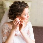 Charming elegant young bride wearing expensive jewelry